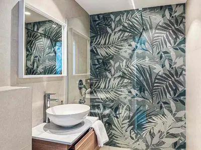 a bathroom with a sink and a mural of leaves at CIRCLE OF 2 in Belgrade