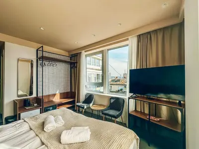 a hotel room with a bed and a large window at CIRCLE OF 2 in Belgrade