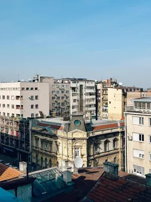 an old building with a clock on it in a city at CIRCLE OF 2 in Belgrade