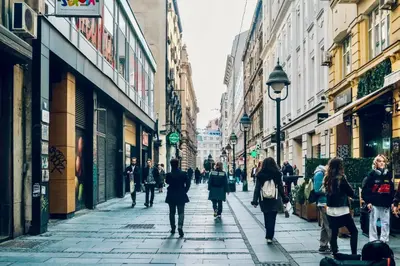 a group of people walking down a city street at CIRCLE OF 2 in Belgrade