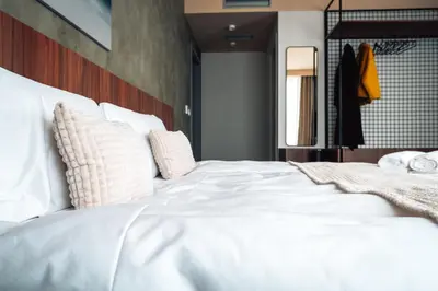 a large white bed with pillows in a bedroom at CIRCLE OF 2 in Belgrade