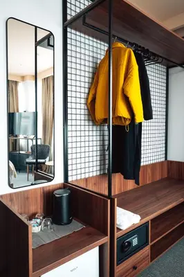 a dressing room with a yellow sweater on a mirror at CIRCLE OF 2 in Belgrade