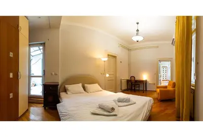 a bedroom with a bed with towels on it at King Peter Apartment in Belgrade