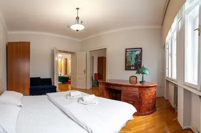 a bedroom with a bed and a desk in it at King Peter Apartment in Belgrade