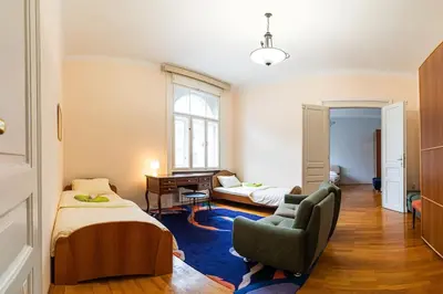 a bedroom with a bed and a chair and a desk at King Peter Apartment in Belgrade