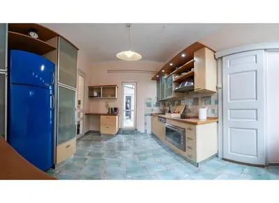 a large kitchen with a blue refrigerator in it at King Peter Apartment in Belgrade
