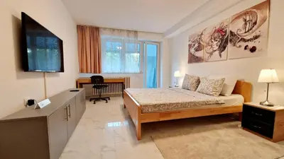 a bedroom with a bed and a flat screen tv at Apartman Laki in Tošin Bunar