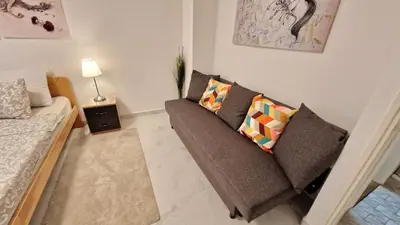 a living room with a couch and a table at Apartman Laki in Tošin Bunar
