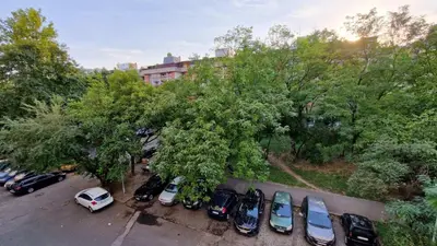 a bunch of cars parked in a parking lot at Apartman Laki in Tošin Bunar
