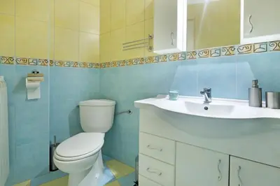 a bathroom with a white toilet and a sink at Illusion Downtown Apartment in Belgrade