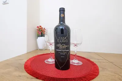 a bottle of wine sitting on a table with two glasses at Illusion Downtown Apartment in Belgrade