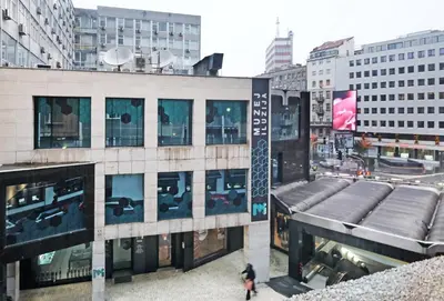 a building with people walking in front of it at Illusion Downtown Apartment in Belgrade