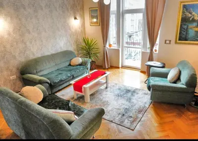 a living room with a couch and two chairs at Gracia apartment in Belgrade