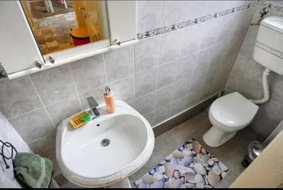a small bathroom with a toilet and a sink at Gracia apartment in Belgrade