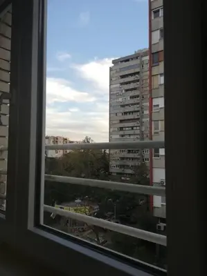 a window with a view of a city at Atelje 11 in Belgrade