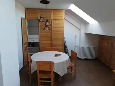 a dining room with a white table and chairs at Atelje 11 in Belgrade
