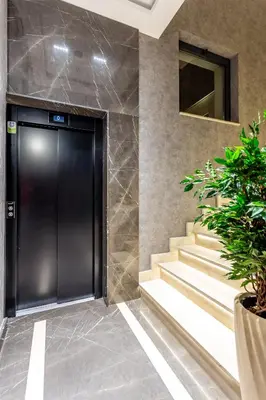 a black elevator door in a building with stairs at The Residence 59 in Belgrade