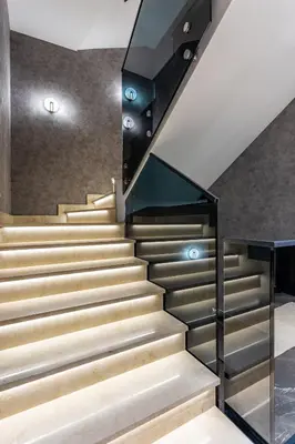 a staircase in a house with a glass railing at The Residence 59 in Belgrade