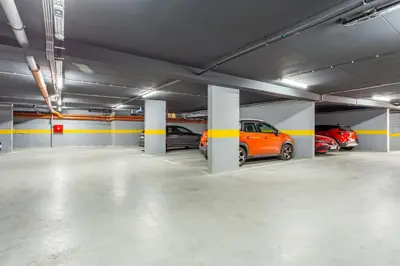 an underground parking garage with cars parked in it at The Residence 59 in Belgrade