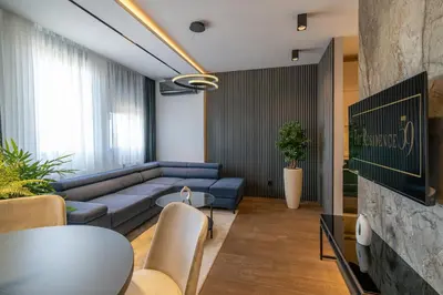 a living room with a blue couch and a table at The Residence 59 in Belgrade
