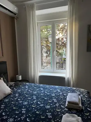 a bedroom with a bed and a window at Old soul of Skadarlija in Belgrade