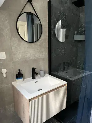 a bathroom with a white sink and a mirror at Old soul of Skadarlija in Belgrade
