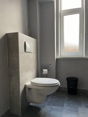 a bathroom with a white toilet and a window at Old soul of Skadarlija in Belgrade
