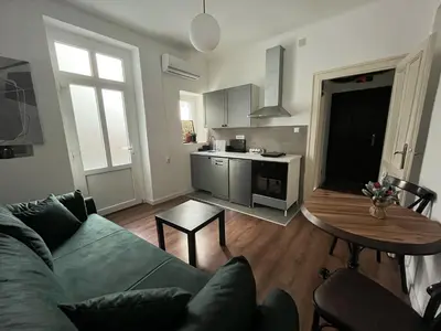 a living room with a couch and a table at Old soul of Skadarlija in Belgrade
