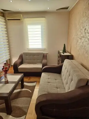 a living room with a couch and a chair at Malina in Belgrade