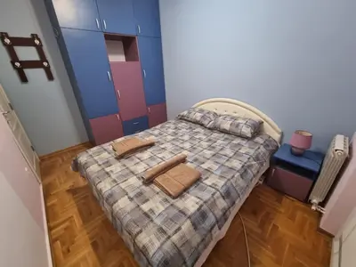 a small bedroom with a bed with two towels on it at Malina in Belgrade