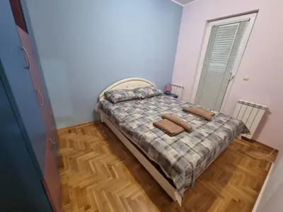 a bedroom with a bed with two towels on it at Malina in Belgrade