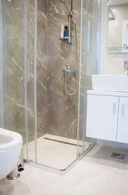 a bathroom with a shower and a toilet and a sink at Downtown, spacious, 2 bedroom apartment in Belgrade