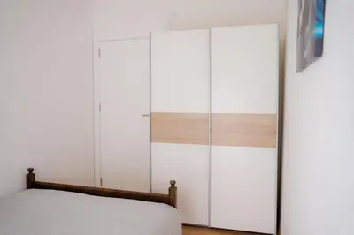 a bedroom with white cabinets and a bed at Downtown, spacious, 2 bedroom apartment in Belgrade
