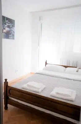 a bedroom with a bed with two towels on it at Downtown, spacious, 2 bedroom apartment in Belgrade