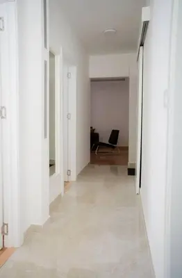 an empty room with a hallway with white walls at Downtown, spacious, 2 bedroom apartment in Belgrade
