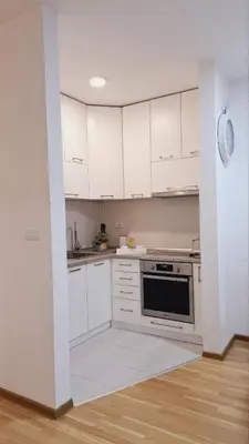 a kitchen with white cabinets and a stove at Maja 2 in Ruma