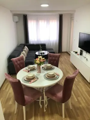 a living room with a table and chairs and a couch at Maja 2 in Ruma
