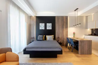 a bedroom with a bed and a desk and a kitchen at Leo Urban Lux, comfort - Central Stay, Free Garage in Belgrade