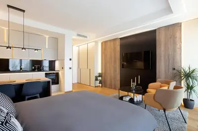 a kitchen and living room with a table and chairs at Leo Urban Lux, comfort - Central Stay, Free Garage in Belgrade