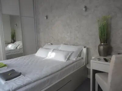 a bed with white pillows and a mirror in a bedroom at Villa Marija M L in Belgrade