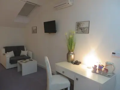 a living room with a desk with a chair and a tv at Villa Marija M L in Belgrade