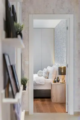 a bedroom with a white bed and a mirror at Melody Apartment in Novi Beograd