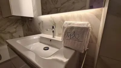 a bathroom with a sink with a towel on it at Melody Apartment in Novi Beograd