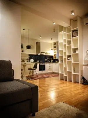 a living room with a couch and a kitchen at Nevski Apartment in Belgrade