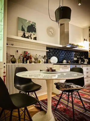 a kitchen with a table and chairs in a kitchen at Nevski Apartment in Belgrade