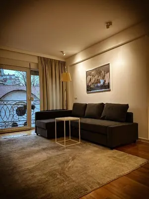 a living room with a couch and a table at Nevski Apartment in Belgrade