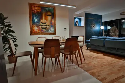 a living room with a table and chairs and a couch at The Crown Pool Villa in Belgrade