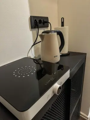 a coffee maker sitting on top of a microwave at The Šljivka in Belgrade
