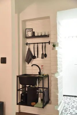 a kitchen with a sink and a shelf with utensils at The Šljivka in Belgrade