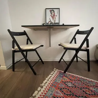 two chairs and a table in a room with a table at The Šljivka in Belgrade